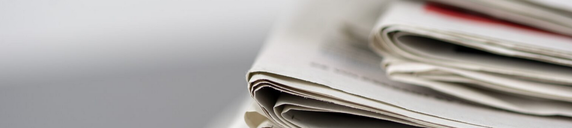 Closeup shot of several newspapers stacked on top of each other